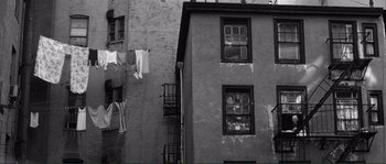Movie still from “Manhattan” (1979), directed by Woody Allen – Clothes hanging on a clothes line outside a brick building; Extreme Wide shot, Low angle