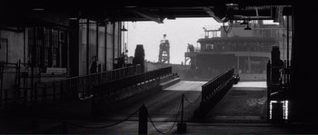 Movie still from “Manhattan” (1979), directed by Woody Allen – A black - and - white photo of an industrial area; Extreme Wide shot, Low angle
