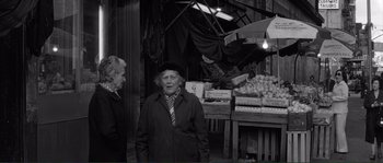 Movie still from “Manhattan” (1979), directed by Woody Allen – Two older women standing in front of a fruit stand; Medium shot, Over the shoulder angle