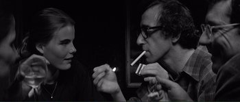 Movie still from “Manhattan” (1979), directed by Woody Allen – A man and a woman are smoking a cigarette together; Close Up shot, Over the shoulder angle