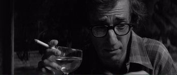Movie still from “Manhattan” (1979), directed by Woody Allen – A black and white photo of a man holding a wine glass; Close Up shot, Low angle