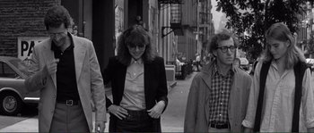 Movie still from “Manhattan” (1979), directed by Woody Allen – Three people walking down a street in a city; Medium shot, Low angle