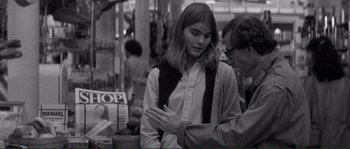 Movie still from “Manhattan” (1979), directed by Woody Allen – A man and a woman are talking in a store; Medium shot, Over the shoulder angle