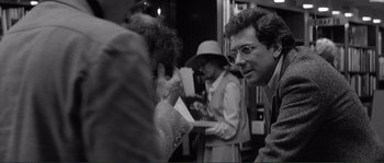Movie still from “Manhattan” (1979), directed by Woody Allen – A group of people standing next to each other on a street; Close Up shot, Over the shoulder angle