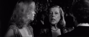 Movie still from “Manhattan” (1979), directed by Woody Allen – Two women are talking to each other in a black and white photo; Close Up shot, Over the shoulder angle