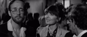 Movie still from “Manhattan” (1979), directed by Woody Allen – A black - and - white photo of a woman smiling; Close Up shot, Over the shoulder angle