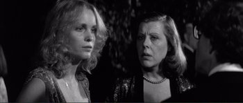 Movie still from “Manhattan” (1979), directed by Woody Allen – A black - and - white photo of two women looking at each other; Close Up shot, Over the shoulder angle