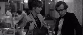 Movie still from “Manhattan” (1979), directed by Woody Allen – A woman holding a purse talking to another woman; Close Up shot, Over the shoulder angle