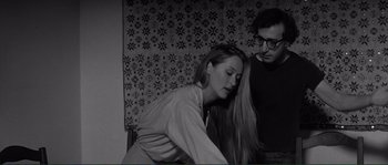 Movie still from “Manhattan” (1979), directed by Woody Allen – A man and a woman sitting next to each other in a room; Medium shot, Over the shoulder angle