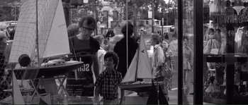 Movie still from “Manhattan” (1979), directed by Woody Allen – A black and white photo of a man and a boy; Wide shot, Over the shoulder angle