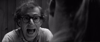 Movie still from “Manhattan” (1979), directed by Woody Allen – A black and white photo of a man with glasses; Close Up shot, Over the shoulder angle