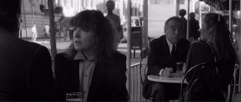 Movie still from “Manhattan” (1979), directed by Woody Allen – A woman sitting at an outdoor table with a man; Medium shot, Over the shoulder angle