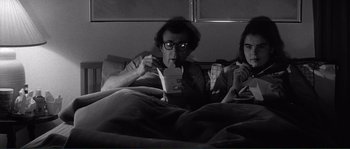 Movie still from “Manhattan” (1979), directed by Woody Allen – A man and a woman sitting in a bed; Medium shot, Low angle
