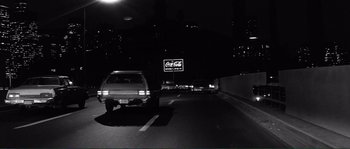 Movie still from “Manhattan” (1979), directed by Woody Allen – A black and white photo of a car on the road; Wide shot, High angle
