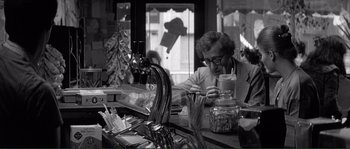 Movie still from “Manhattan” (1979), directed by Woody Allen – An older woman sitting at a table in front of a window; Medium shot, Over the shoulder angle