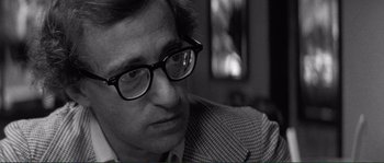 Movie still from “Manhattan” (1979), directed by Woody Allen – A person wearing glasses; Close Up shot, Over the shoulder angle