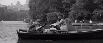 Movie still from “Manhattan” (1979), directed by Woody Allen – A man and a woman sitting in a boat on a river; Wide shot, High angle