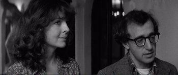 Movie still from “Manhattan” (1979), directed by Woody Allen – A woman standing next to another woman in a room; Close Up shot, Over the shoulder angle