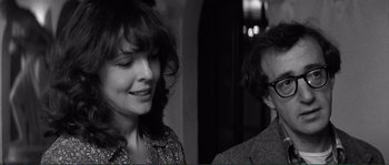 Movie still from “Manhattan” (1979), directed by Woody Allen – A woman standing next to a man wearing glasses; Close Up shot, Over the shoulder angle