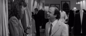 Movie still from “Manhattan” (1979), directed by Woody Allen – A black and white photo of a man in a suit and tie; Medium shot, Over the shoulder angle