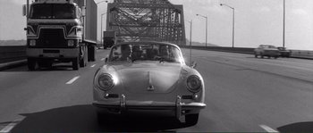 Movie still from “Manhattan” (1979), directed by Woody Allen – An old photo of a car on the road; Wide shot, High angle