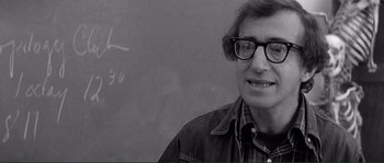 Movie still from “Manhattan” (1979), directed by Woody Allen – A black and white photo of a man in front of a chalkboard; Close Up shot, Over the shoulder angle