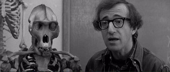 Movie still from “Manhattan” (1979), directed by Woody Allen – A man with glasses is looking at a skeleton; Close Up shot, Over the shoulder angle