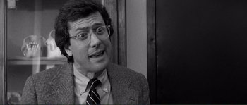 Movie still from “Manhattan” (1979), directed by Woody Allen – An older man wearing glasses and a jacket; Close Up shot, Over the shoulder angle