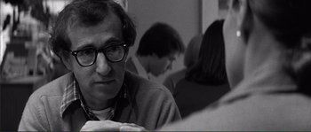 Movie still from “Manhattan” (1979), directed by Woody Allen – A black and white photo of a man with glasses; Close Up shot, Over the shoulder angle