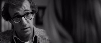 Movie still from “Manhattan” (1979), directed by Woody Allen – Black and white photograph of a man wearing glasses; Close Up shot, Over the shoulder angle