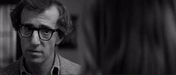 Movie still from “Manhattan” (1979), directed by Woody Allen – An older man wearing glasses and a jacket; Close Up shot, Over the shoulder angle