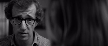 Movie still from “Manhattan” (1979), directed by Woody Allen – Black and white photograph of a man with glasses; Close Up shot, Over the shoulder angle