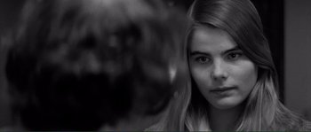 Movie still from “Manhattan” (1979), directed by Woody Allen – A black - and - white photo of a woman with long hair; Close Up shot, Over the shoulder angle