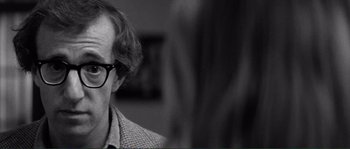 Movie still from “Manhattan” (1979), directed by Woody Allen – An older man wearing glasses and a checkered shirt; Close Up shot, Over the shoulder angle