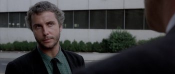 Movie still from “Manhunter” (1986), directed by Michael Mann – A person wearing a suit and tie; Close Up shot, Over the shoulder angle