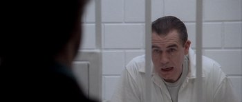 Movie still from “Manhunter” (1986), directed by Michael Mann – A man in a jail cell with his mouth wide open; Close Up shot, Over the shoulder angle