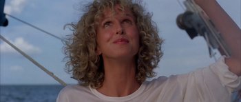 Movie still from “Manhunter” (1986), directed by Michael Mann – A person with curly hair looking up; Close Up shot, Low angle