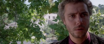 Movie still from “Manhunter” (1986), directed by Michael Mann – A man's face in front of trees; Close Up shot, Low angle