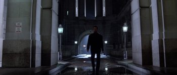 A man walking down a street at night