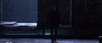 Movie still from “Manhunter” (1986), directed by Michael Mann – A man standing in the middle of the night; Wide shot, Low angle