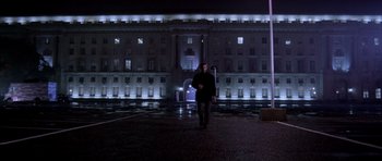 Movie still from “Manhunter” (1986), directed by Michael Mann – A man walking in front of a building at night; Extreme Wide shot, Low angle