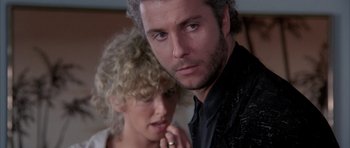 Movie still from “Manhunter” (1986), directed by Michael Mann – A man and a woman looking at the camera; Close Up shot, Over the shoulder angle
