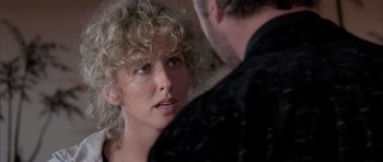 Movie still from “Manhunter” (1986), directed by Michael Mann – A woman with blonde curly hair looking at a man; Close Up shot, Over the shoulder angle
