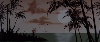 Movie still from “Manhunter” (1986), directed by Michael Mann – A painting of the ocean with a full moon in the background; Extreme Wide shot, High angle