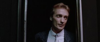 Movie still from “Manhunter” (1986), directed by Michael Mann – A person wearing a suit and tie; Close Up shot, Low angle