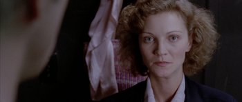 Movie still from “Manhunter” (1986), directed by Michael Mann – A person holding a cloth; Close Up shot, Over the shoulder angle