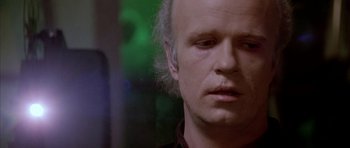 Movie still from “Manhunter” (1986), directed by Michael Mann – A person with a bald head; Close Up shot, Over the shoulder angle