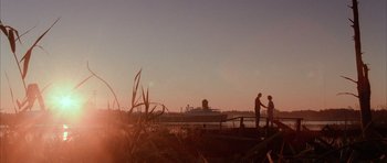 Movie still from “Manhunter” (1986), directed by Michael Mann – Two people standing on the shore of a body of water; Extreme Wide shot, Low angle