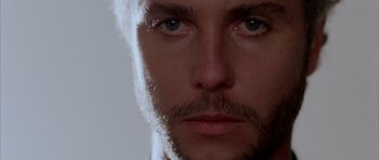 Movie still from “Manhunter” (1986), directed by Michael Mann – A man's eyes and face; Extreme Close Up shot, Low angle