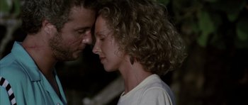 Movie still from “Manhunter” (1986), directed by Michael Mann – A man and a woman face to face with their eyes closed; Close Up shot, Low angle